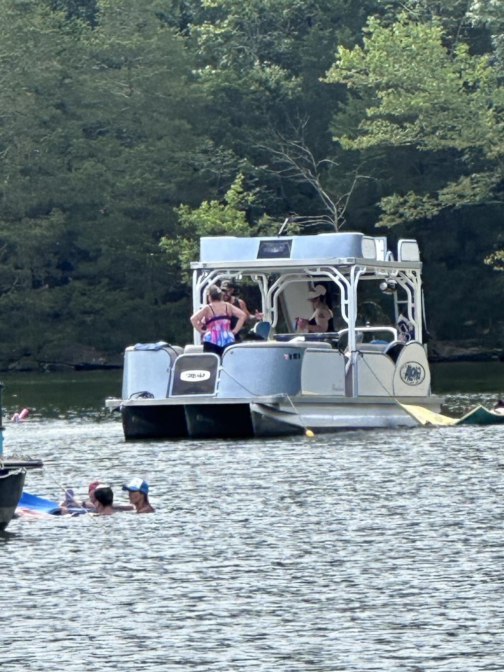 Double-decker party pontoon with slide cruising on Canyon Lake, Texas